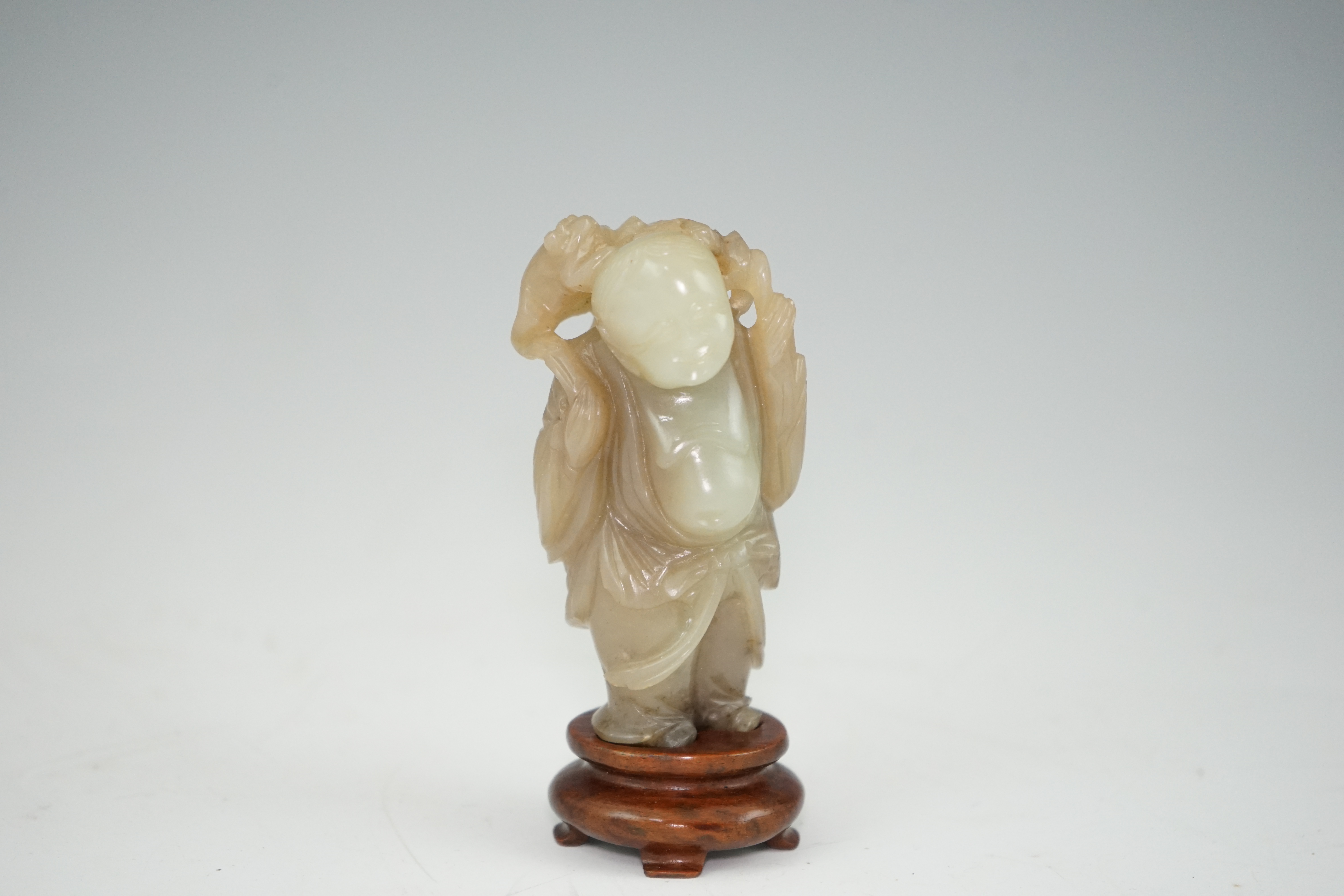 A Chinese pale celadon and brown jade group of Liu Hai and his three legged toad, Qianlong period (1736-95)